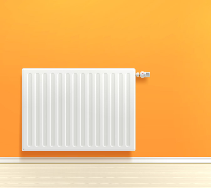 Heizkörper vor orangener Wand